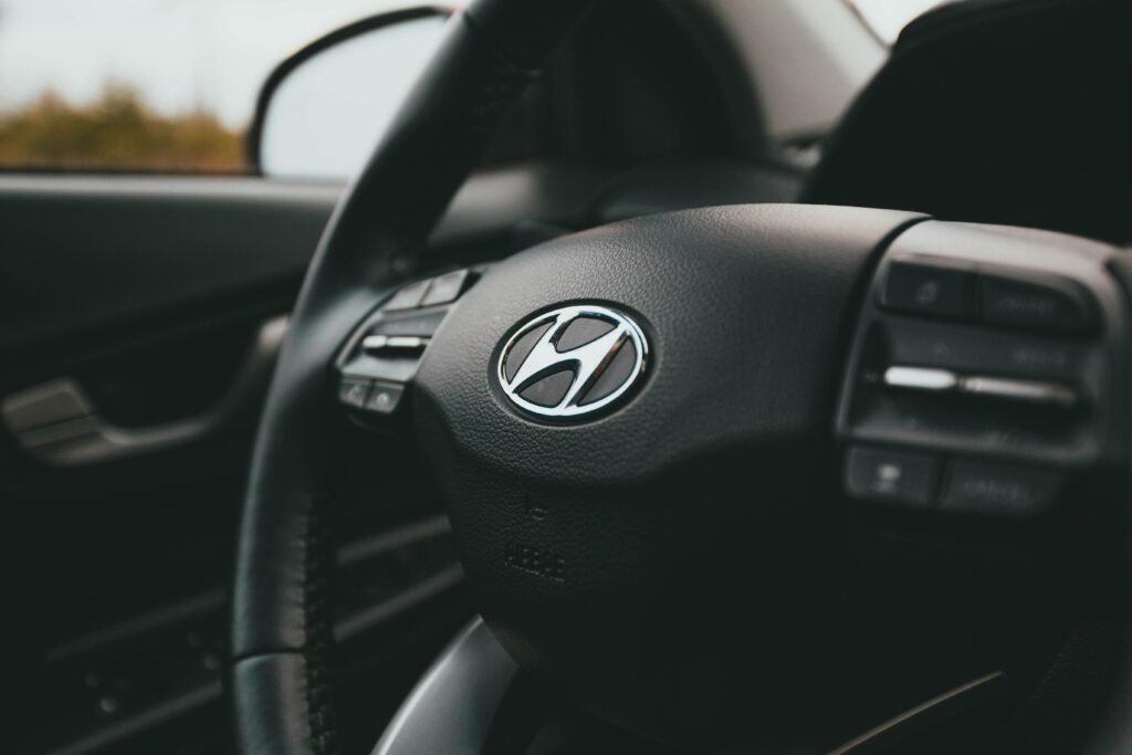 A close-up image focusing on a Hyundai steering wheel inside a car, highlighting design details.