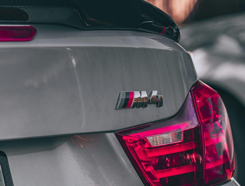 Detailed view of a BMW M4 taillight parked in San Francisco, showcasing its sleek design.