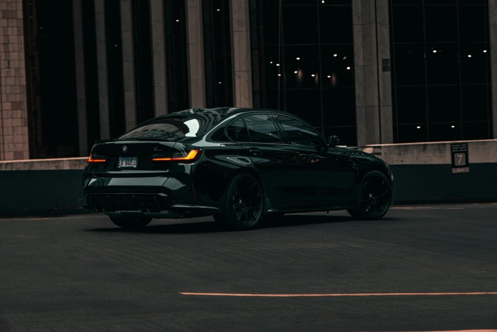Stylish black car captured in a dimly lit urban environment in Chicago, enhancing its sleek design.